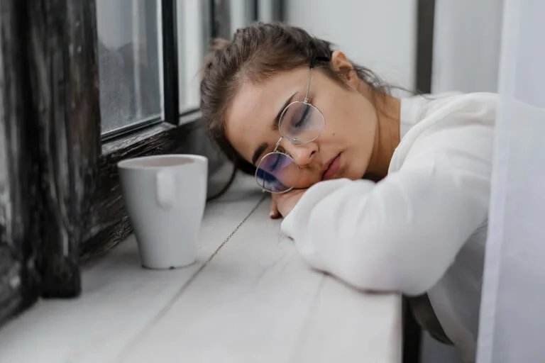 Person lying awake at night, unable to sleep, lost in thought